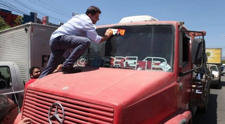 Cid Gomes sobe em caminhão durante ato de campanha do PT no Ceará para colar adesivo